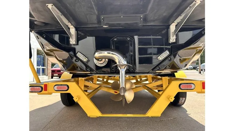 Slide: The Image of 2023 Nautique Super Air Nautique S21 boat on yellow trailer, rear view. - 8