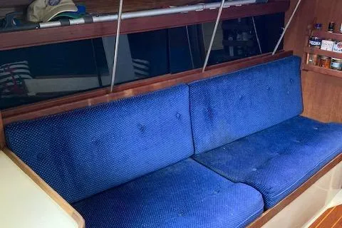 Slide: The Image of Interior of a 1988 Catalina 34 sailboat with blue cushioned seating. - 3