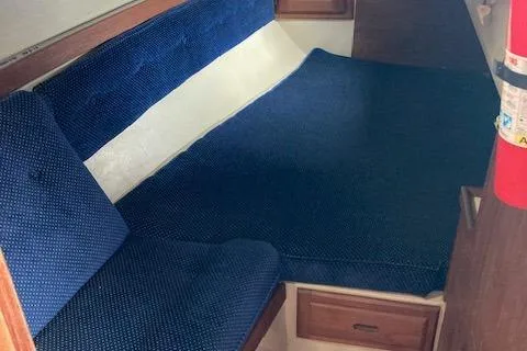 Slide: The Image of Interior cabin of a 1988 Catalina 34 sailboat with blue upholstery. - 7