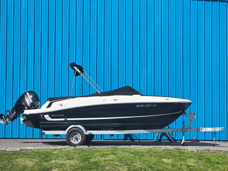 Slide: The Image of 2019 Bayliner VR5 Bowrider OB on trailer, parked against blue wall. - 1