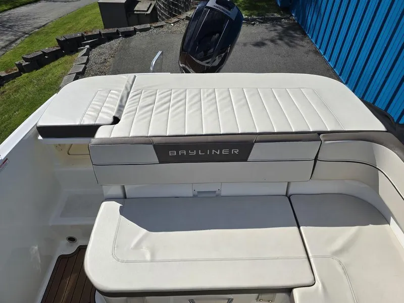 Slide: The Image of 2019 Bayliner VR5 Bowrider OB boat with white cushioned seating and outboard motor. - 5