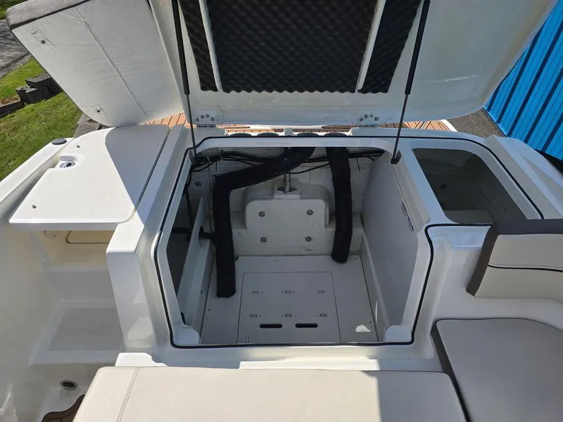 Slide: The Image of Open engine compartment of 2019 Bayliner VR5 Bowrider OB boat, showcasing interior details. - 6