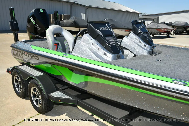 Slide: The Image of 2021 Nitro Z20 Pro Pack boat with dual engines and sleek design on a trailer. - 13
