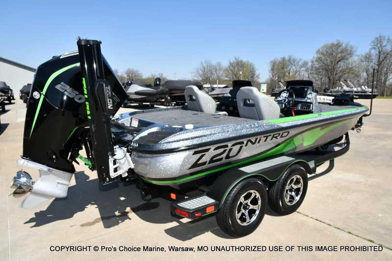 Slide: The Image of 2021 Nitro Z20 Pro Pack boat with powerful engine, sleek design, and dual-axle trailer. - 18