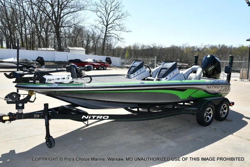 Slide: The Image of 2021 Nitro Z20 Pro Pack boat on trailer, featuring sleek design and vibrant green accents. - 28