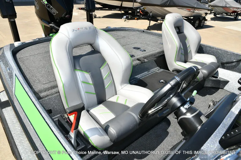 Slide: The Image of 2021 Nitro Z20 Pro Pack boat interior with gray and green seats, steering wheel visible. - 37