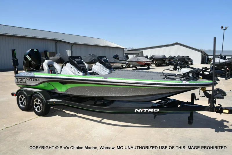 Slide: The Image of 2021 Nitro Z20 Pro Pack boat on trailer, green and gray design, parked outdoors. - 81