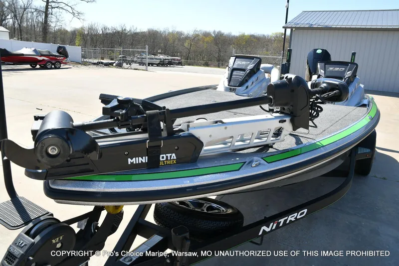 Slide: The Image of 2021 Nitro Z20 Pro Pack boat with Minn Kota Ultrex trolling motor, parked outdoors. - 9