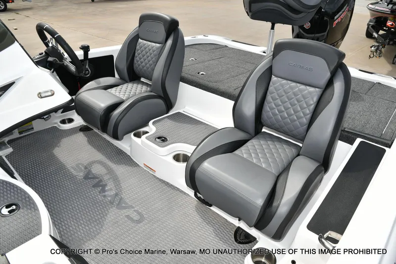 Slide: The Image of 2023 Caymas CX 18 boat interior with gray leather seats and steering wheel. - 14
