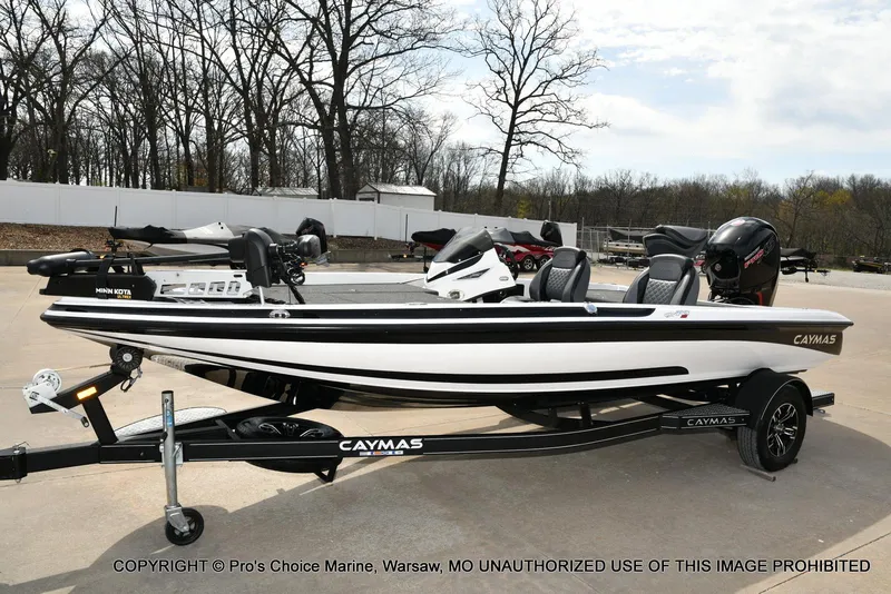 Slide: The Image of 2023 Caymas CX 18 boat with 150 Mercury Pro-XS engine on trailer, parked outdoors. - 28