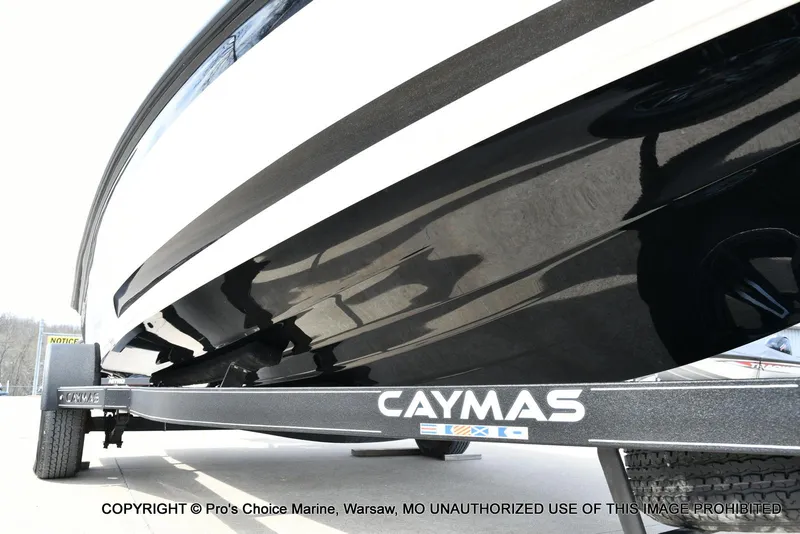 Slide: The Image of 2023 Caymas CX 18 boat on trailer, featuring sleek black hull design. - 34