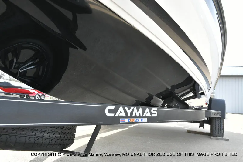 Slide: The Image of 2023 Caymas CX 18 boat on trailer, featuring sleek black hull design. - 35