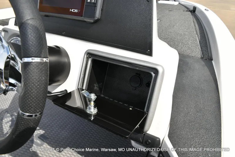 Slide: The Image of 2023 Caymas CX 18 boat dashboard with steering wheel and storage compartment. - 42