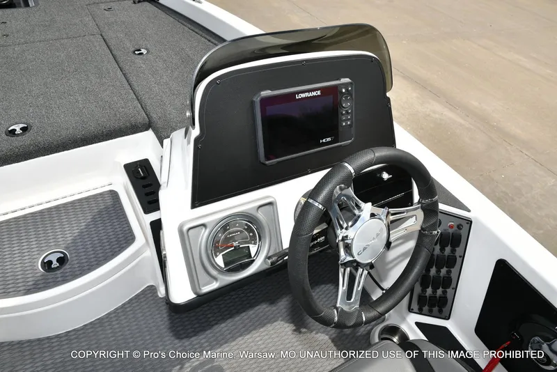 Slide: The Image of 2023 Caymas CX 18 boat dashboard with steering wheel and Lowrance display. - 46