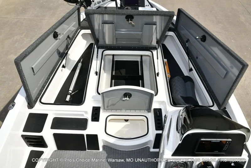 Slide: The Image of 2023 Caymas CX 18 boat interior with open storage compartments and 150 Mercury Pro-XS engine. - 9