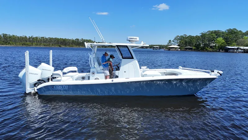 Slide: The Image of 2022 Costa Custom Boats 264 HC on calm water, featuring sleek design and modern amenities. - 0