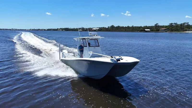 Slide: The Image of 2022 Costa Custom Boats 264 HC cruising on a sunny day in open water. - 14