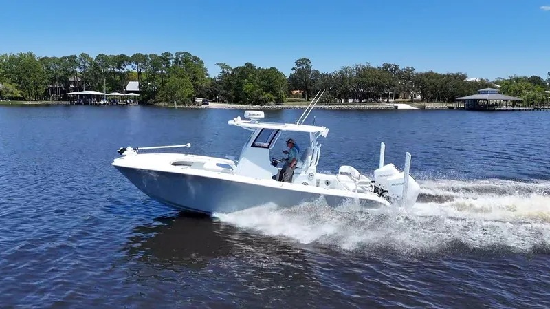 Slide: The Image of 2022 Costa Custom Boats 264 HC cruising on a lake under clear blue skies. - 15