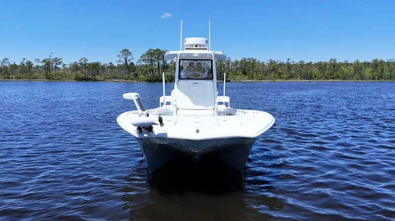 Slide: The Image of 2022 Costa Custom Boats 264 HC on calm water, front view, clear sky. - 2