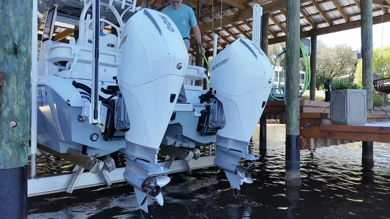 Slide: The Image of 2022 Costa Custom Boats 264 HC with dual outboard engines in a docked position. - 21