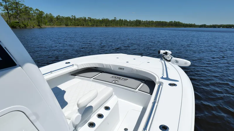 Slide: The Image of 2022 Costa Custom Boats 264 HC on serene lake with lush forest backdrop. - 24
