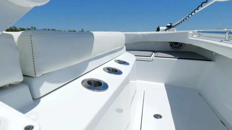 Slide: The Image of 2022 Costa Custom Boats 264 HC interior with white seating and cup holders. - 25