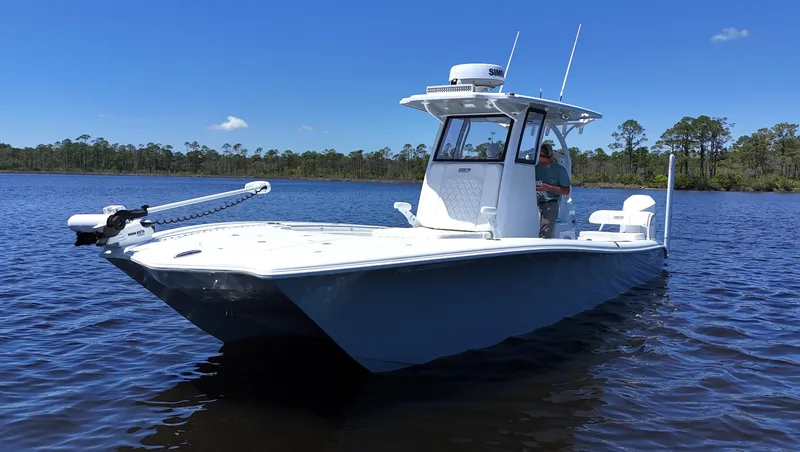 Slide: The Image of 2022 Costa Custom Boats 264 HC on calm water under clear blue sky. - 3