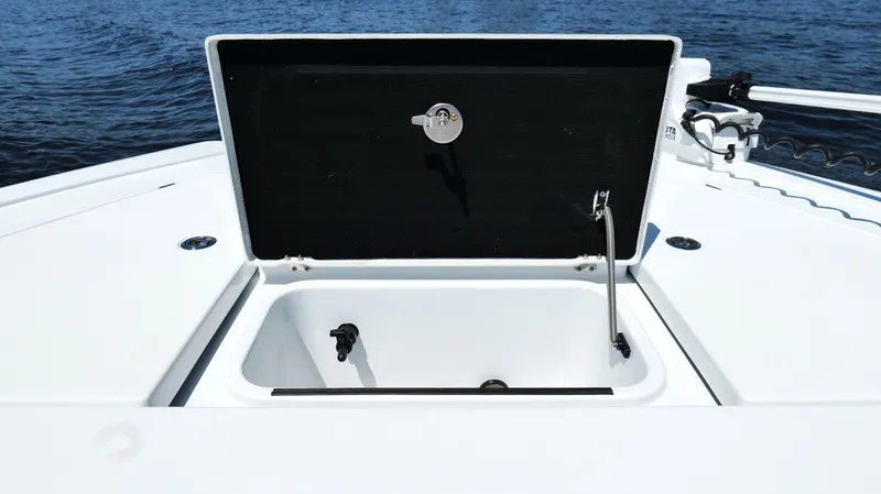 Slide: The Image of Open storage compartment on 2022 Costa Custom Boats 264 HC, with ocean backdrop. - 30