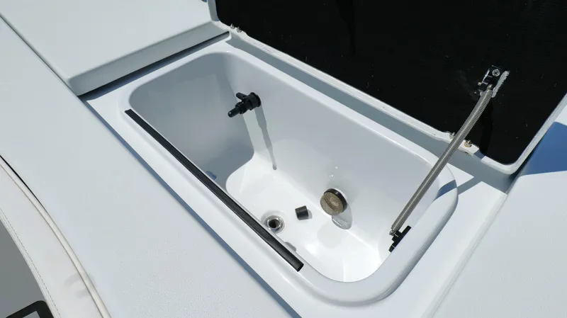 Slide: The Image of Livewell compartment on 2022 Costa Custom Boats 264 HC, featuring a sleek, white interior design. - 33