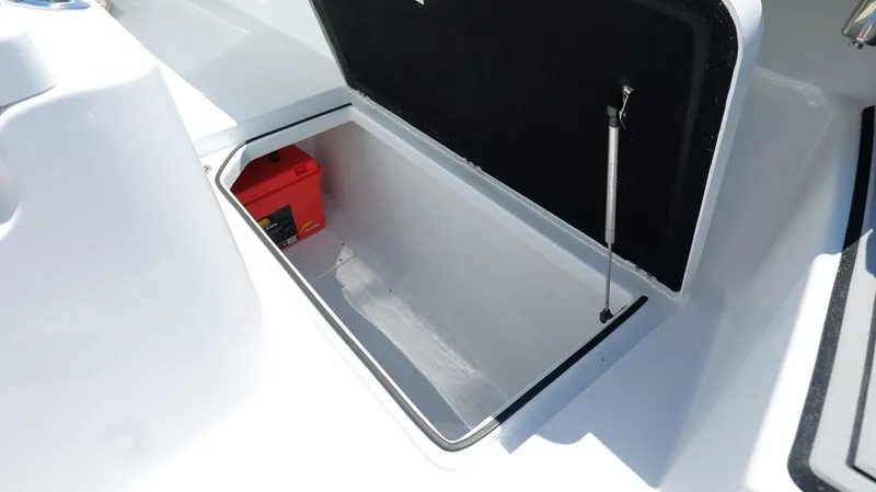 Slide: The Image of Storage compartment of 2022 Costa Custom Boats 264 HC, featuring a red battery inside. - 36