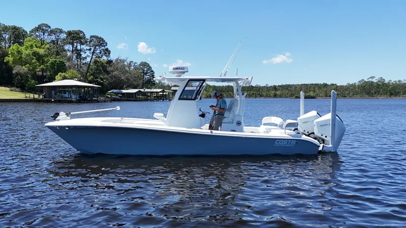 Slide: The Image of 2022 Costa Custom Boats 264 HC on a serene lake with clear blue skies. - 4