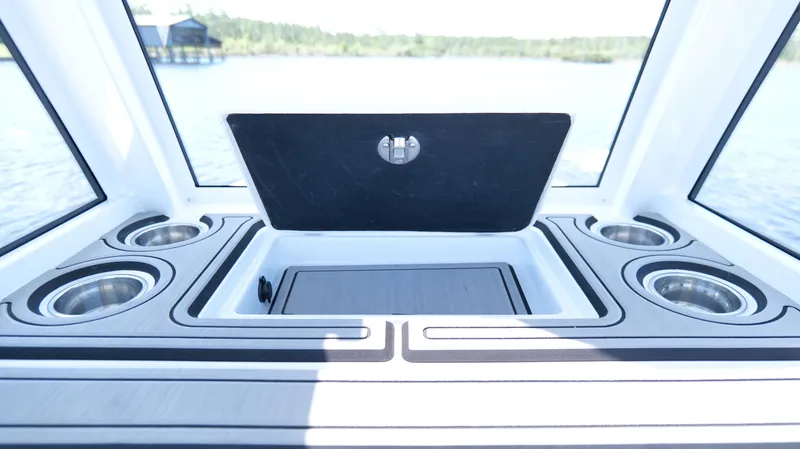 Slide: The Image of 2022 Costa Custom Boats 264 HC interior with cup holders and storage compartment. - 43