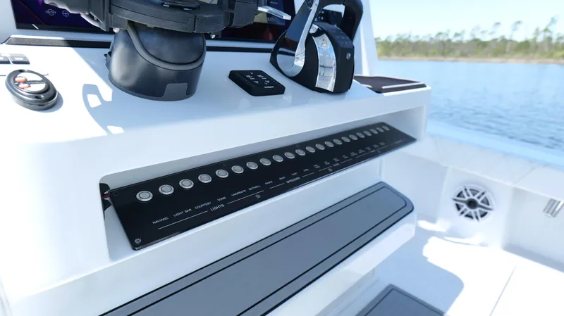 Slide: The Image of Control panel of 2022 Costa Custom Boats 264 HC on a sunny day. - 45