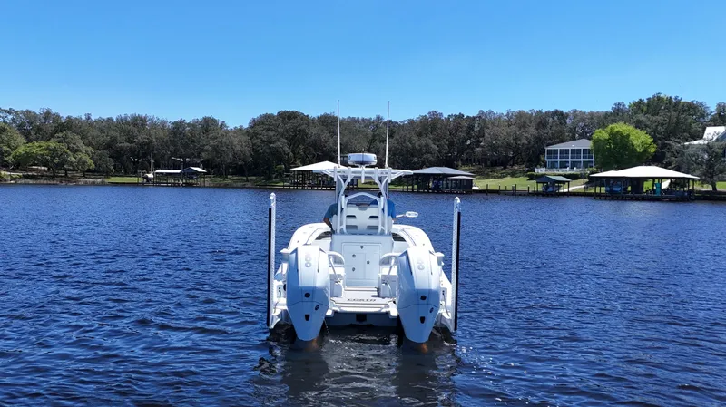 Slide: The Image of Costa Custom Boats 264 HC 2022 model on a serene lake with clear blue skies. - 6