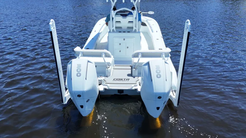 Slide: The Image of 2022 Costa Custom Boats 264 HC on water, rear view, dual engines visible. - 8