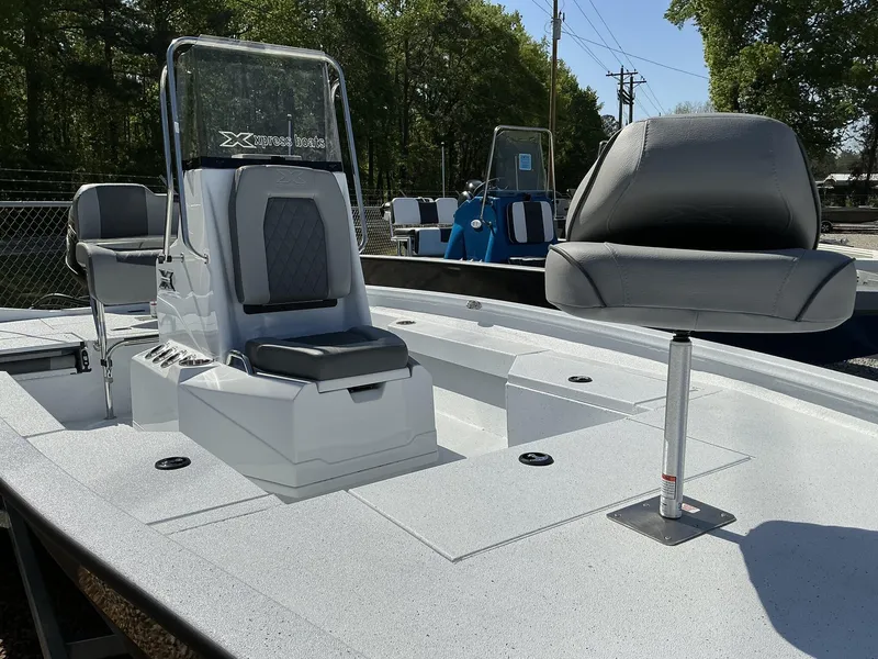 Slide: The Image of 2025 Xpress Hyper-Lift Series H20B boat with new console and seating, outdoors. - 5