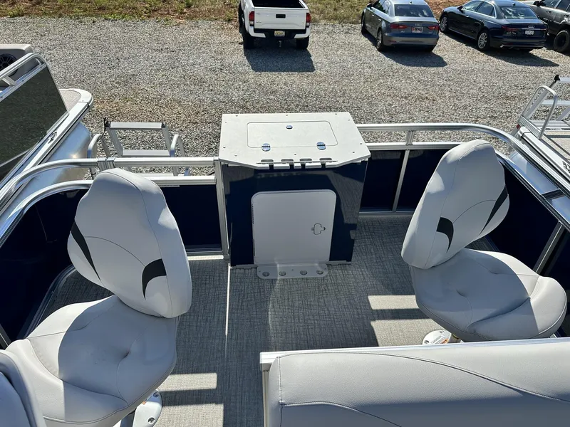 Slide: The Image of 2024 Avalon VTX Quad Fish boat interior with swivel seats and storage compartment. - 10