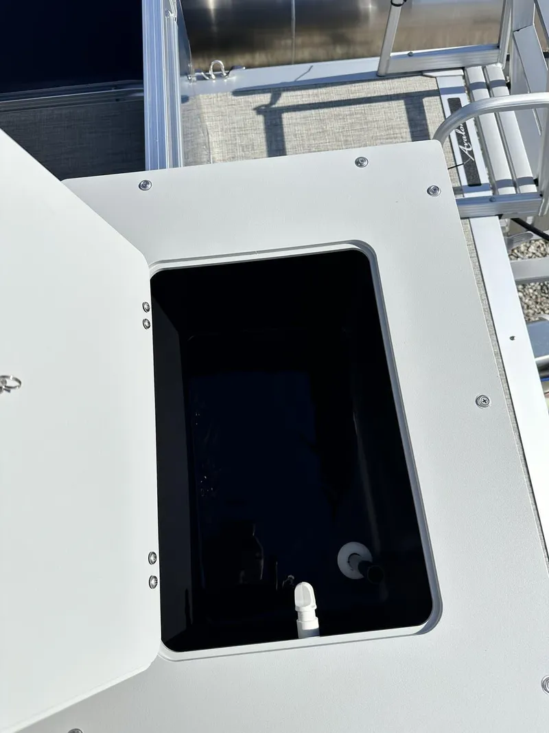 Slide: The Image of Open storage compartment on 2024 Avalon VTX Quad Fish boat. - 8