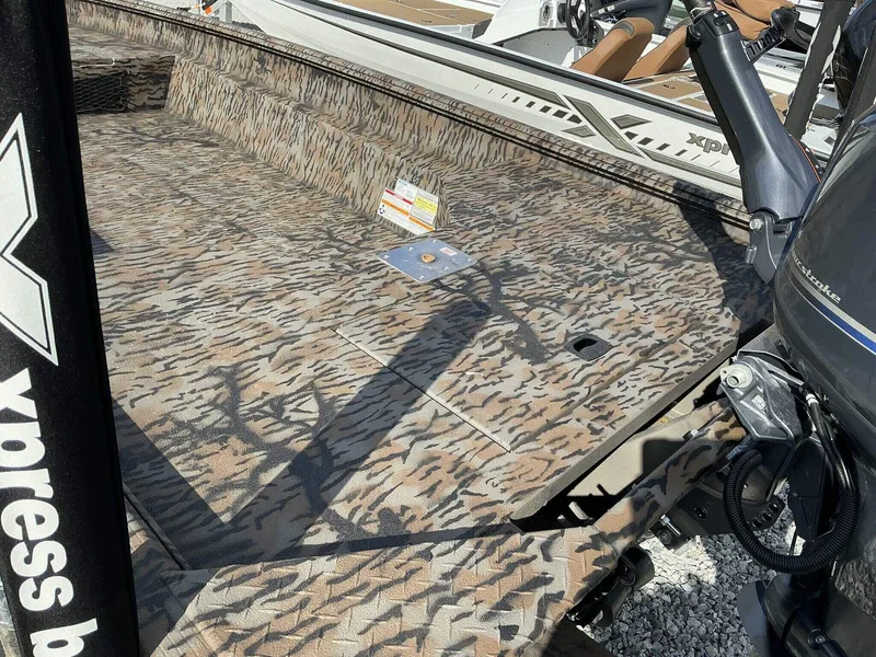 Slide: The Image of 2025 Xpress HD Series HD16DBX boat with camouflage deck and powerful outboard motor. - 5
