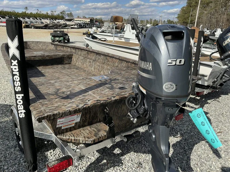 Slide: The Image of 2025 Xpress HD Series HD16DBX boat with Yamaha 50 engine, parked on gravel. - 7