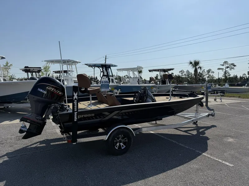 Slide: The Image of 2025 Xpress Hyper-Lift Series H18 bass boat on trailer in parking lot. - 2