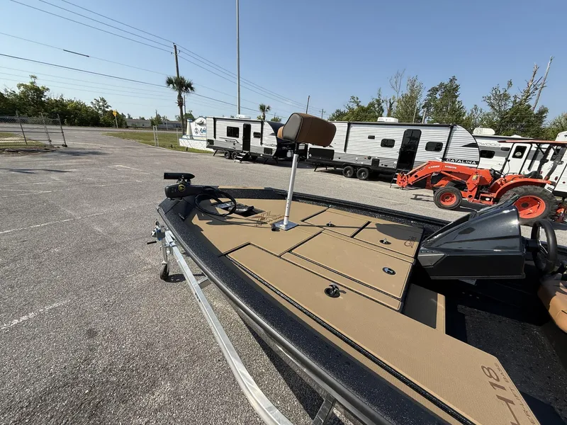 Slide: The Image of 2025 Xpress Hyper-Lift Series H18 bass boat on trailer, parked near RVs and tractor. - 9