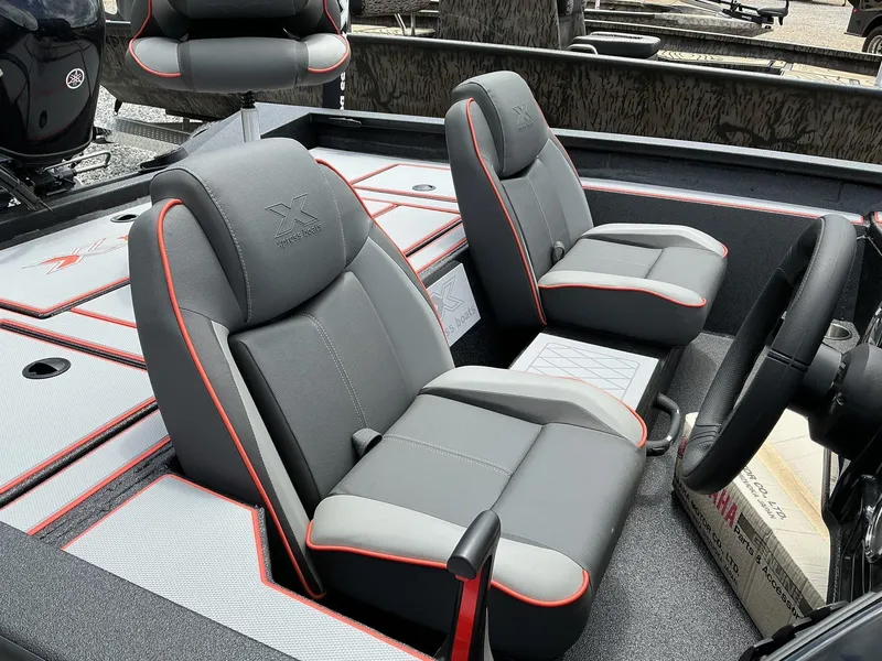 Slide: The Image of 2025 Xpress Hyper-Lift Series H18 bass boat interior with gray and red seating. - 4