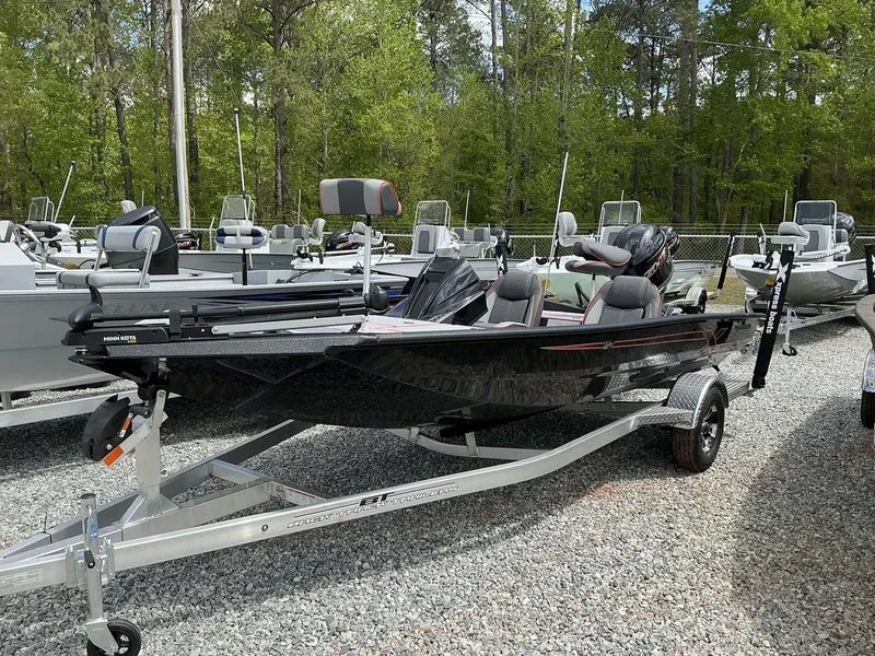 Slide: The Image of 2025 Xpress Hyper-Lift Series H18 bass boat on trailer, parked outdoors. - 5
