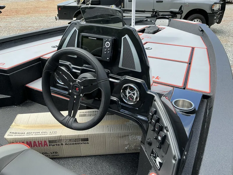 Slide: The Image of 2025 Xpress Hyper-Lift Series H18 bass boat dashboard with steering wheel and electronics. - 8