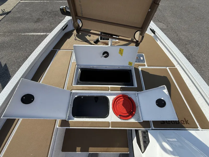 Slide: The Image of 2025 Xpress Hyper-Lift H18 Crappie boat deck with open storage compartments. - 10