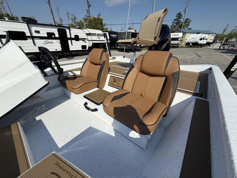 Slide: The Image of 2025 Xpress Hyper-Lift H18 Crappie boat interior with tan seats and steering wheel. - 8