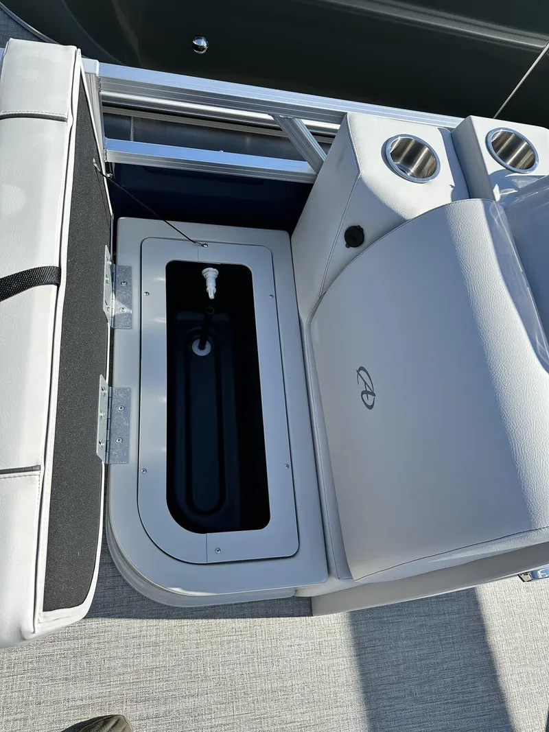 Slide: The Image of 2024 Avalon VTX Quad Fish boat interior with open storage compartment and cup holders. - 3