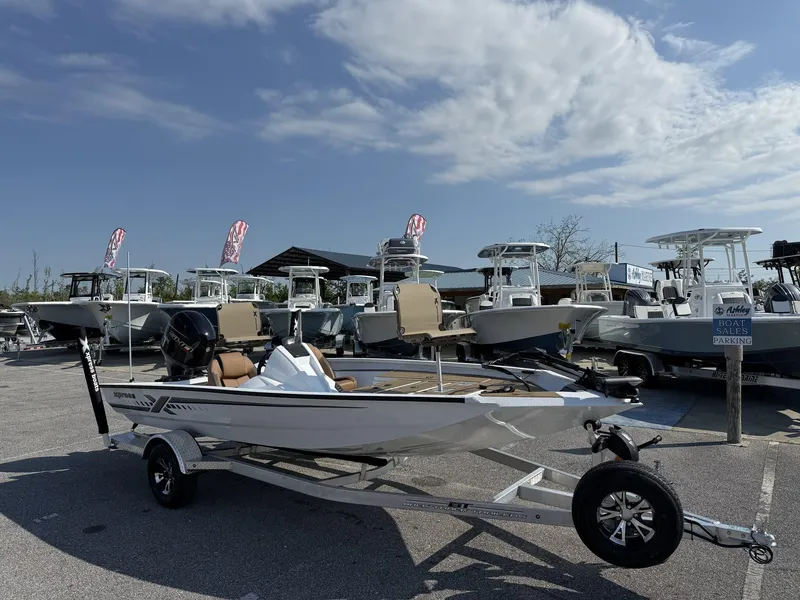 Slide: The Image of 2025 Xpress Hyper-Lift Series H18 Crappie Model boat on trailer at dealership. - 1