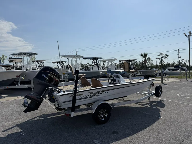 Slide: The Image of 2025 Xpress Hyper-Lift Series H18 Crappie Model boat on trailer in parking lot. - 2